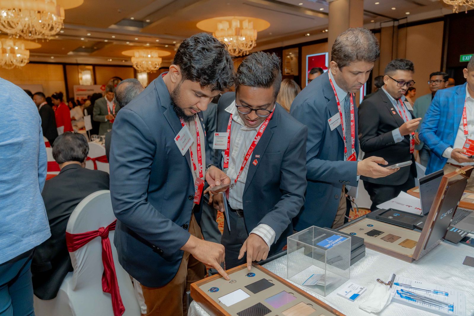 BNI members exploring the TapID device collection at the conference booth